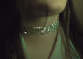 woman wearing gray choker necklace