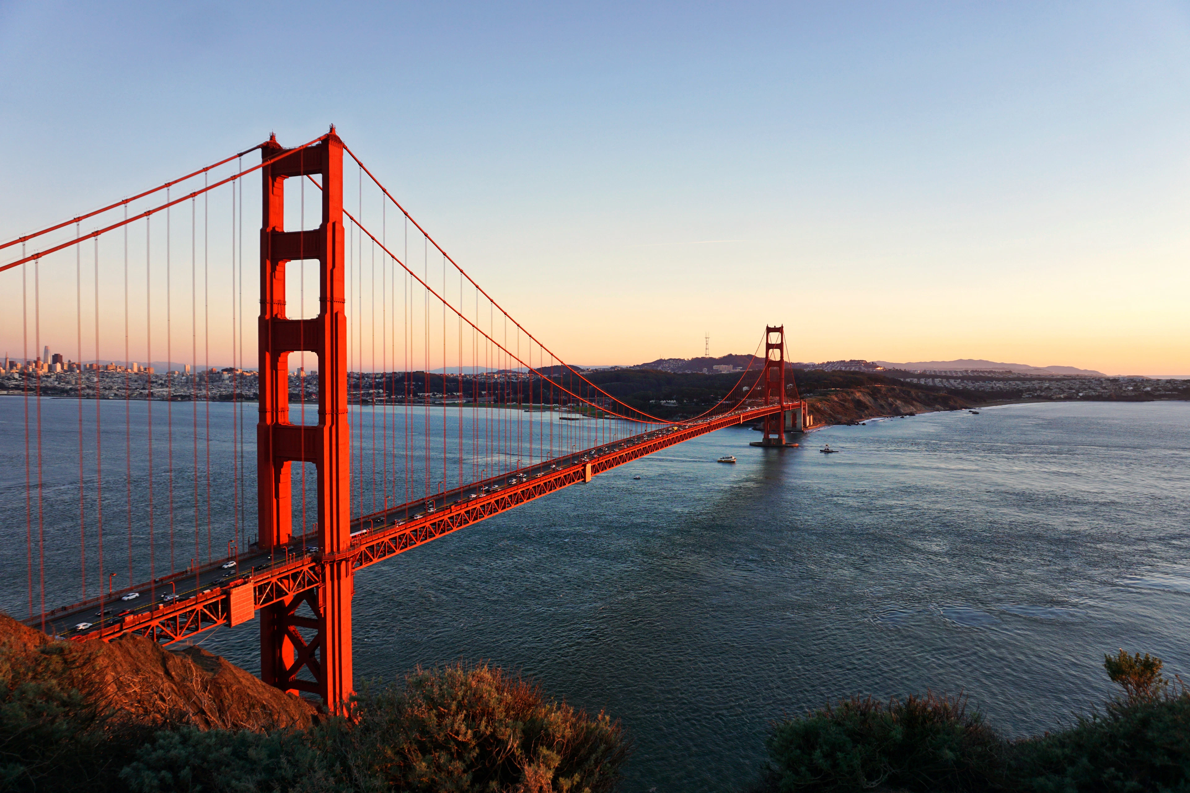 The Golden Gate Bridge in evening light with the bay and the headlands stretching away behind it