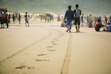Tourists enjoying a sunny beach in Ensenada with local vendors nearby