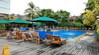 A serene outdoor pool area with sun loungers.