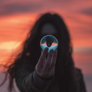 selective focus photography of woman holding ball