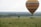 Couple enjoying a hot air balloon ride over the Maasai Mara with vast plains below.
