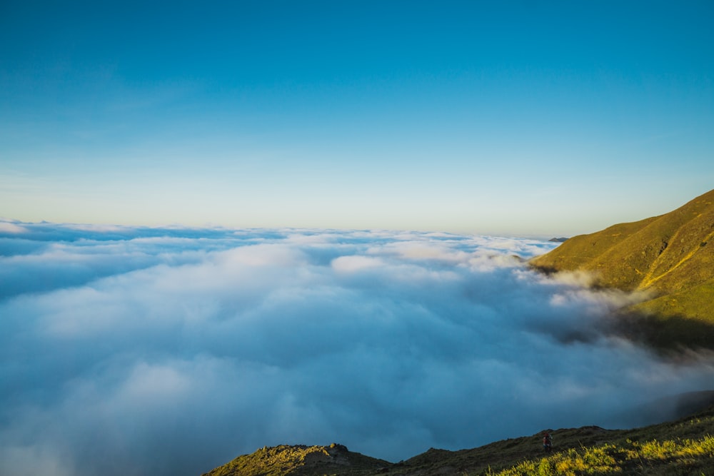 above cloud photo of green mountain