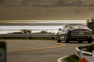 selective focus photo of gray coupe on road