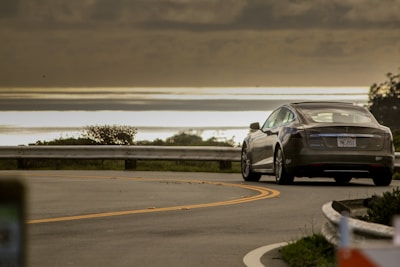 selective focus photo of gray coupe on road