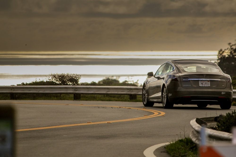 selective focus photo of gray coupe on road