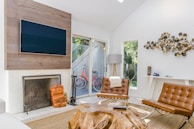 two tufted brown leather chairs in front of brown wood stump center table
