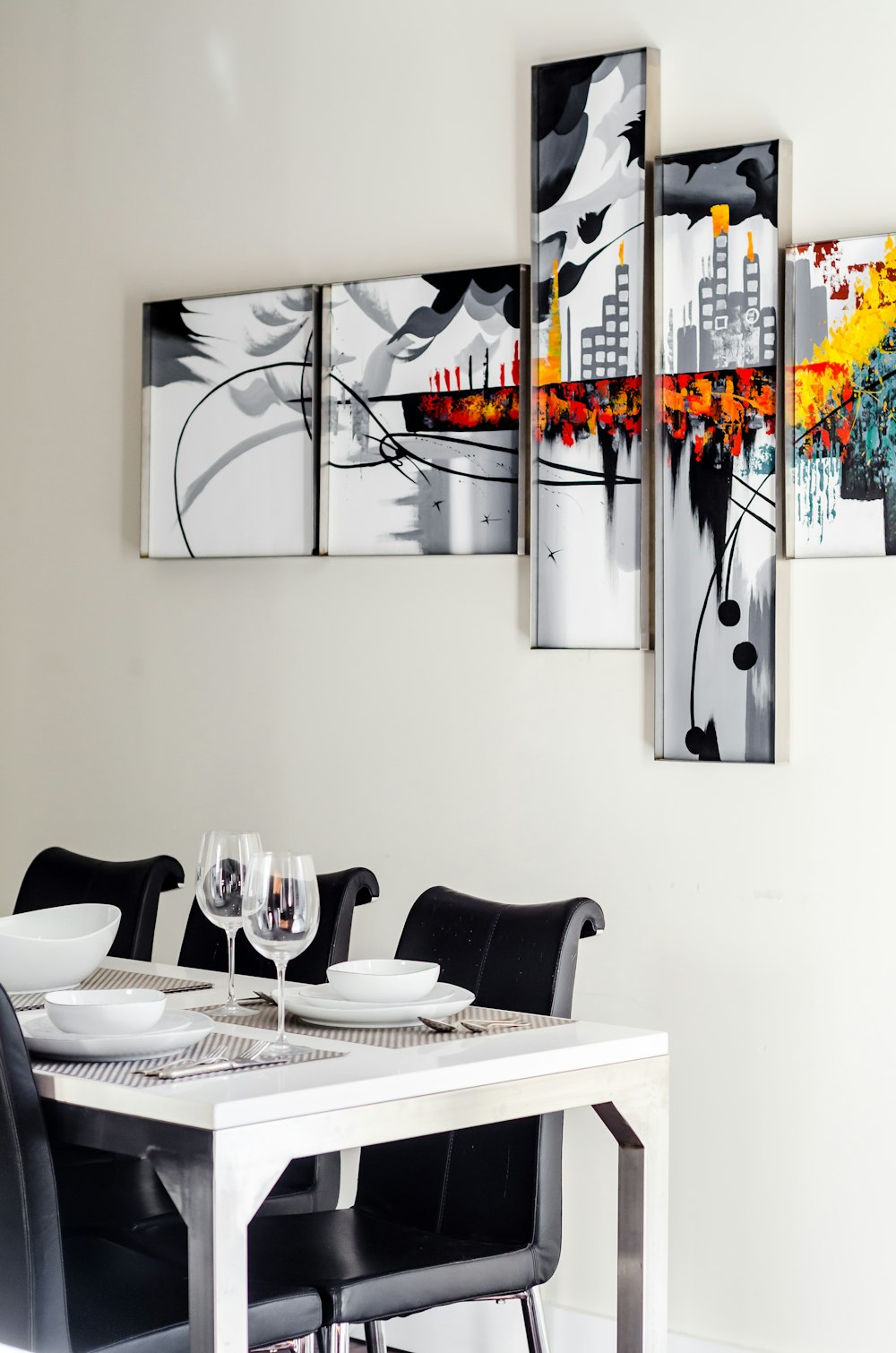 two clear wine glasses on white wooden dining table