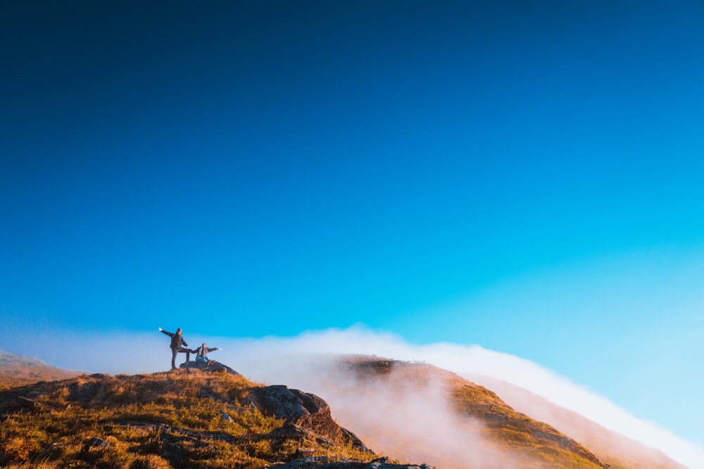 two person on mountain during daytime