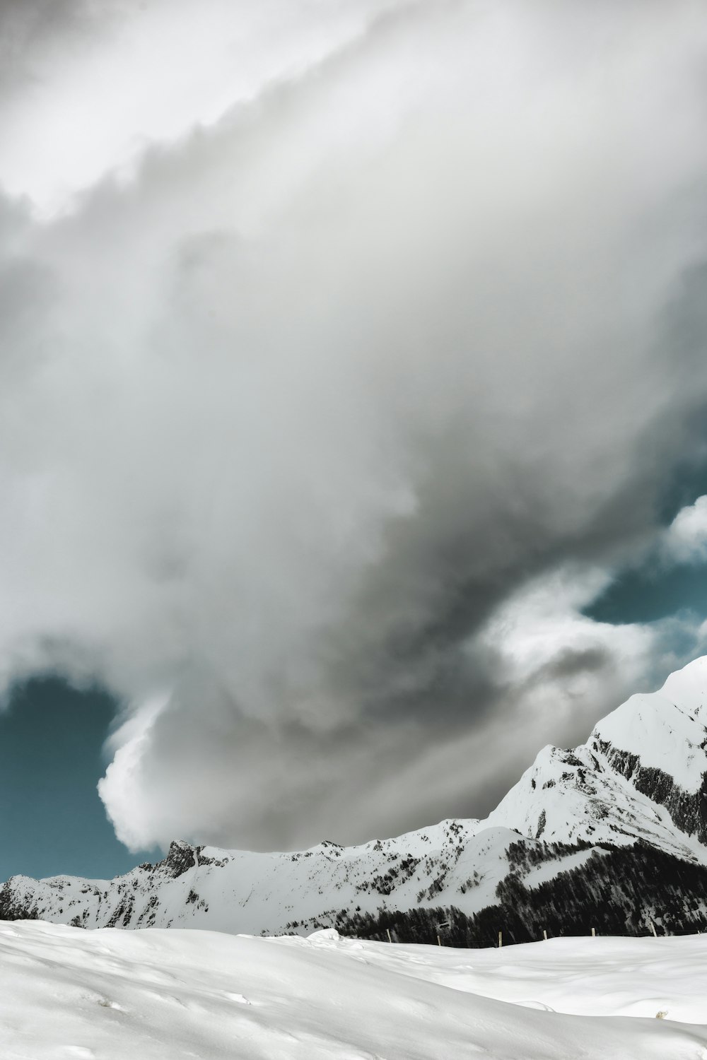 photo of ice covered mountains during cloudy daytime