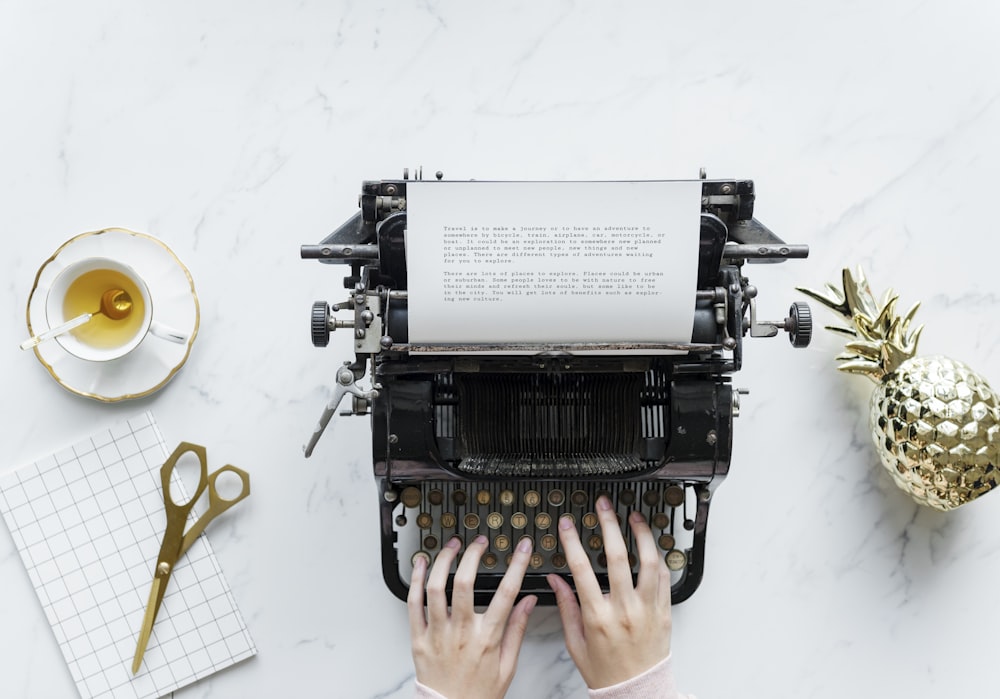 person using typewriter