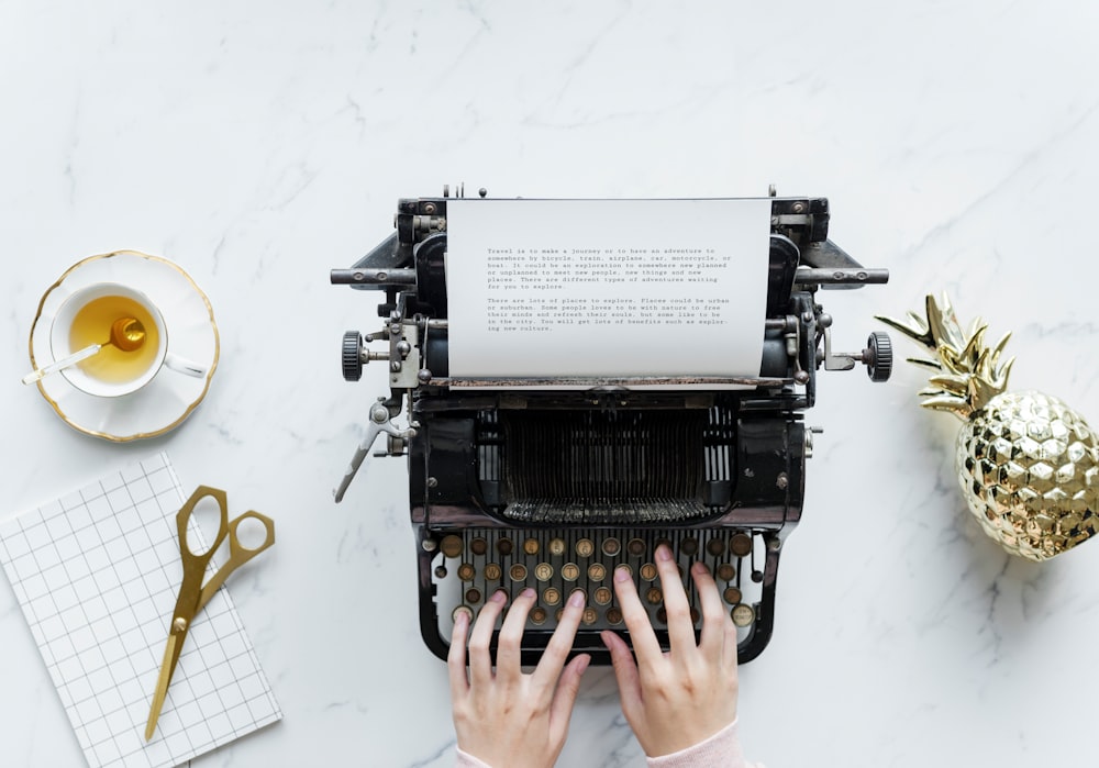 person using typewriter