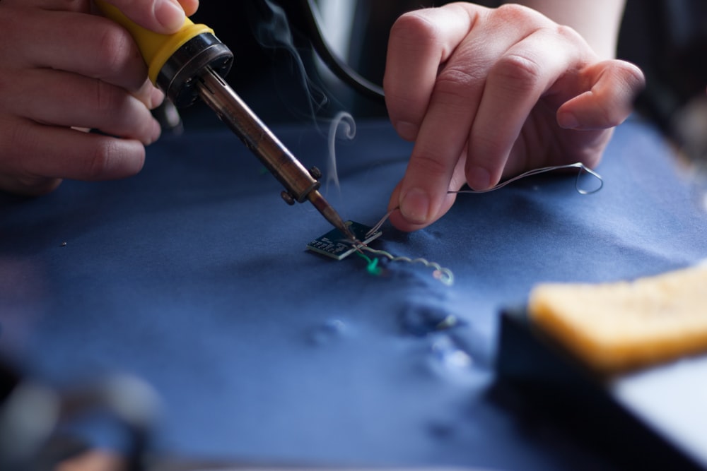 person using soldering iron