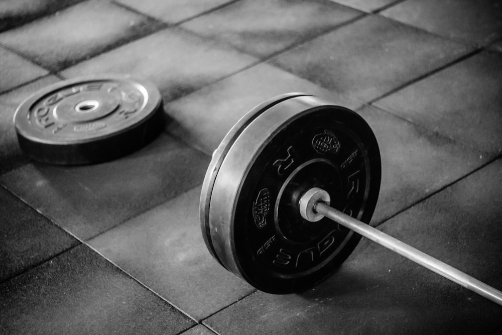 black barbell on tile flooring