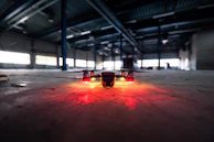 Team of engineers assembling a high-tech drone in a dimly lit workshop.