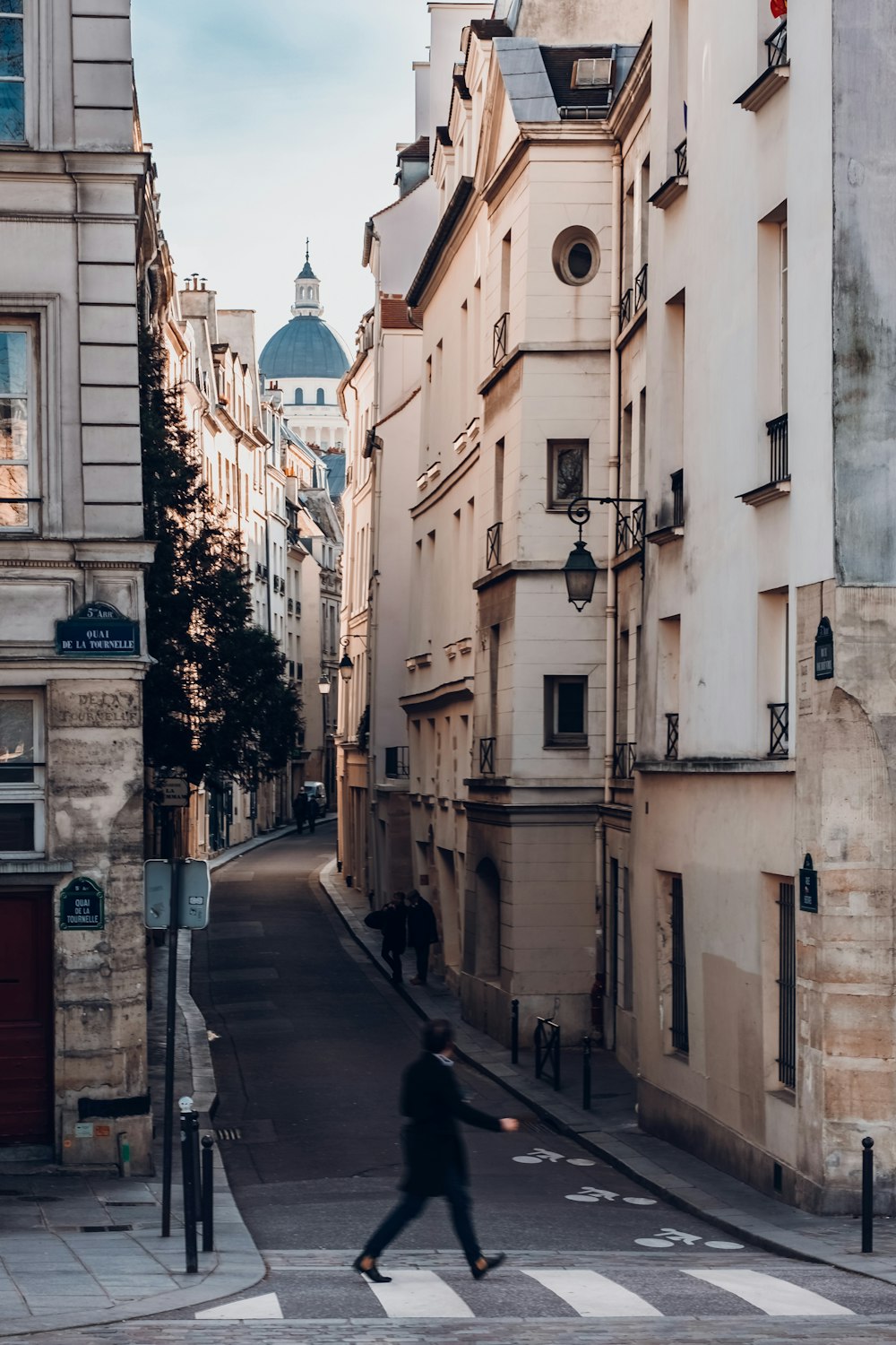 photography of person walking on sideway looking at leftside with buildings