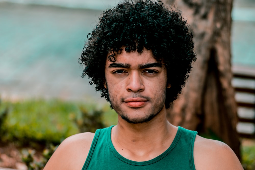 selective focus photo of man wearing green tank top