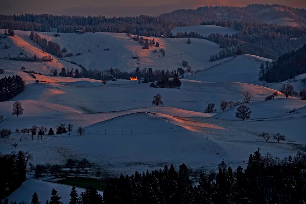 aerial photo of snow-covered hills during golden hour
