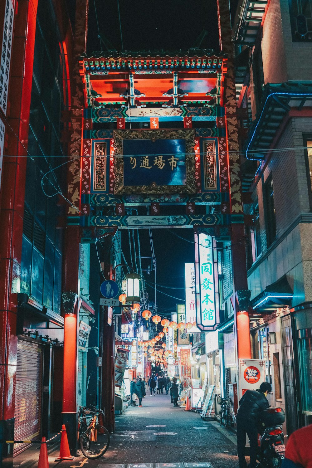 people walking on street in between buildings