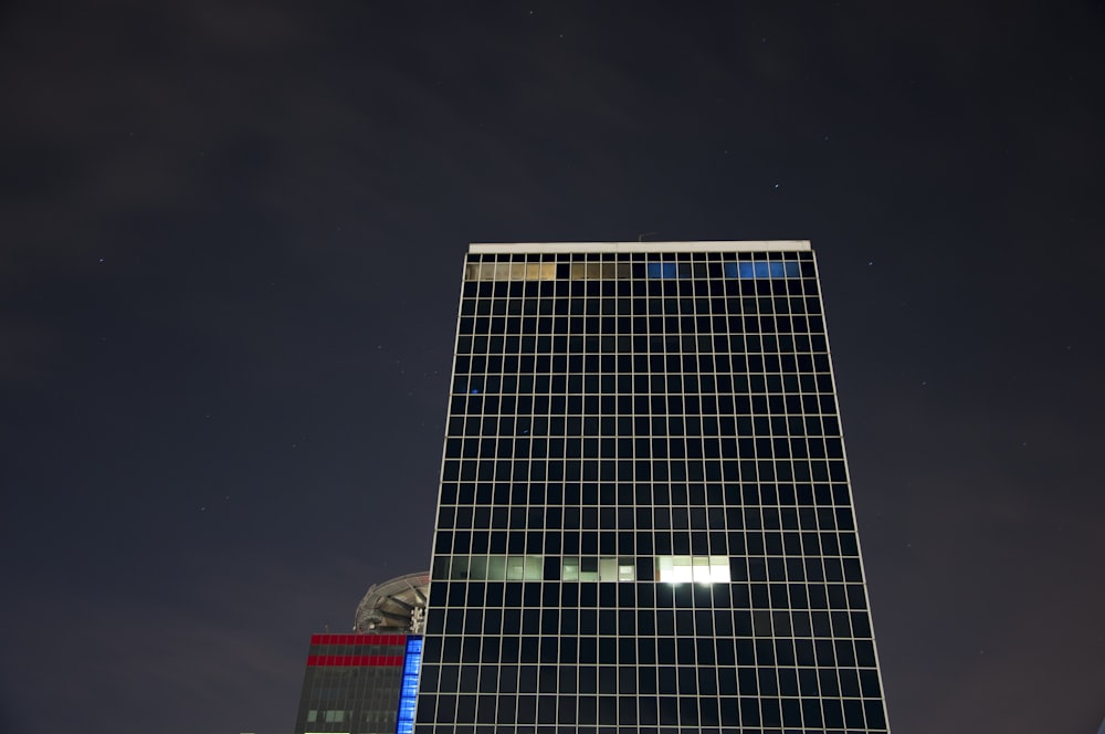 low-angle photo of high-rise building during night time