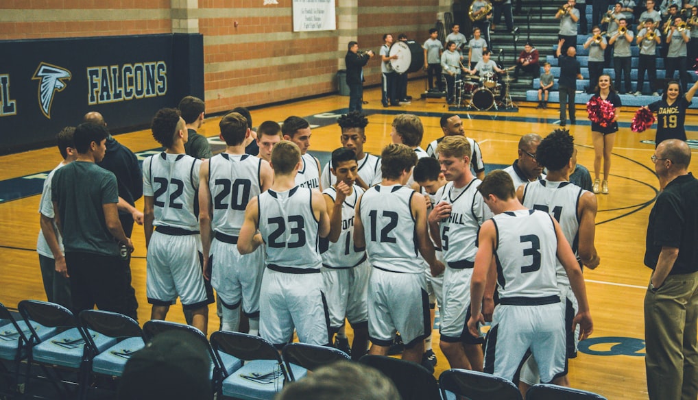 basketball team standing on courtside