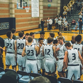 basketball team standing on courtside