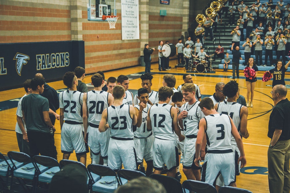 basketball team standing on courtside