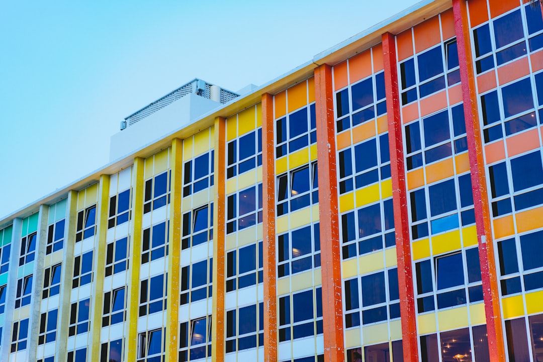 architectural photography of multicolored building under blue sky