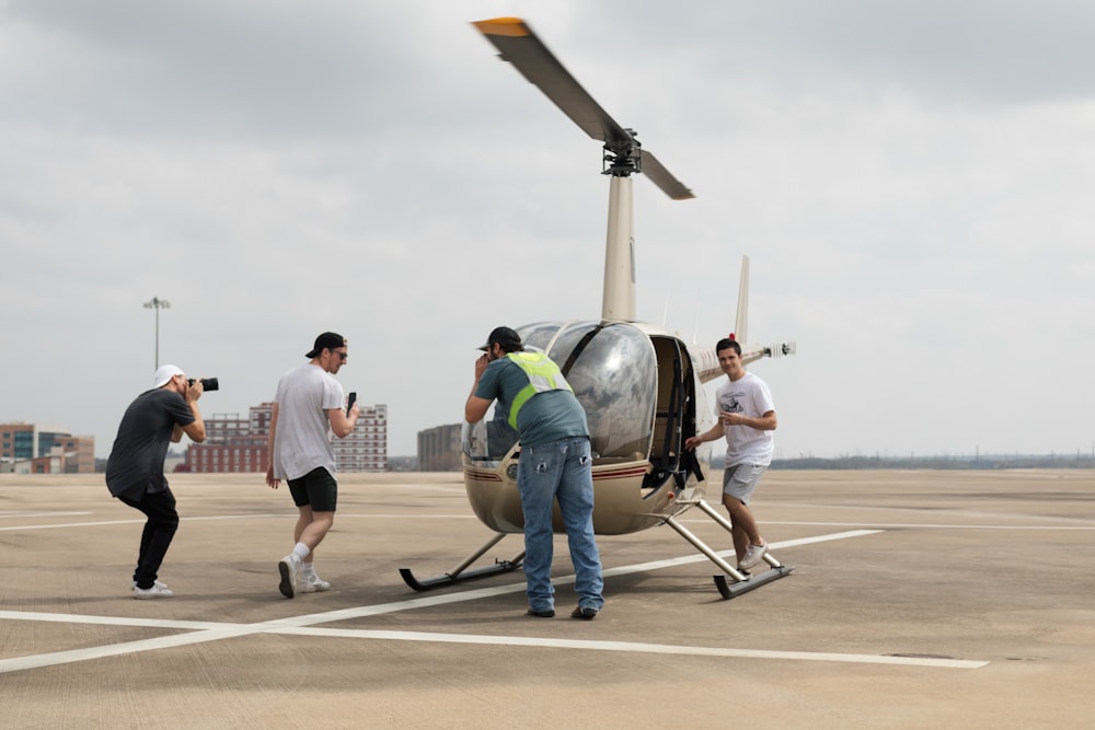 four men surrounding helicopter