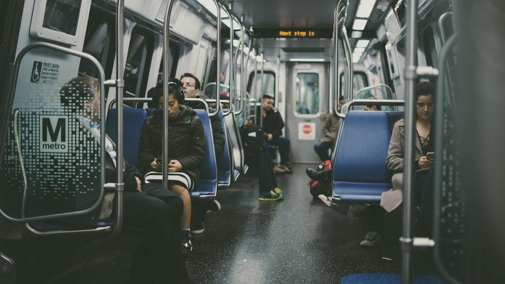 group of person sitting on blue chairs