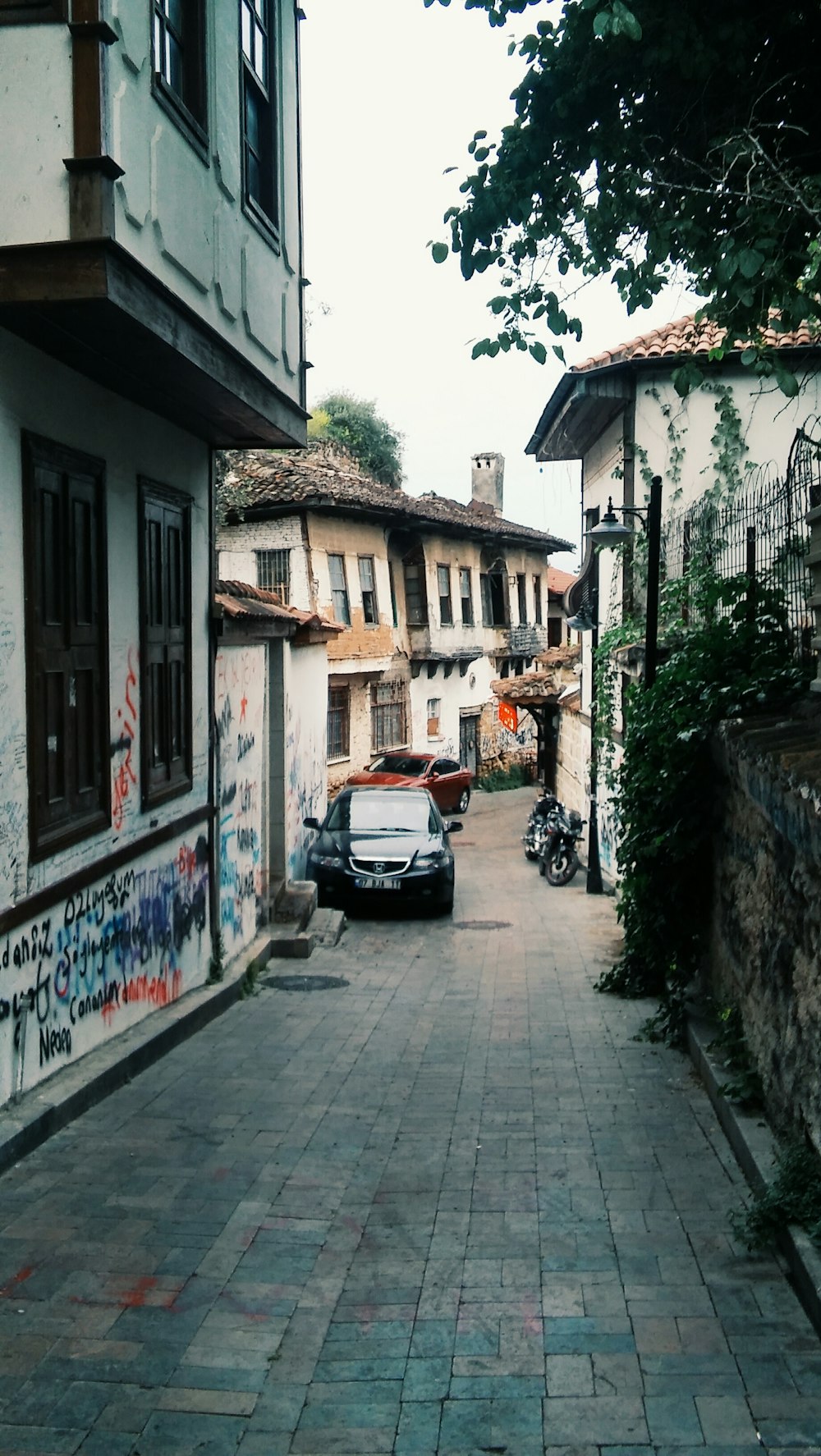 street photography of parked black car at village