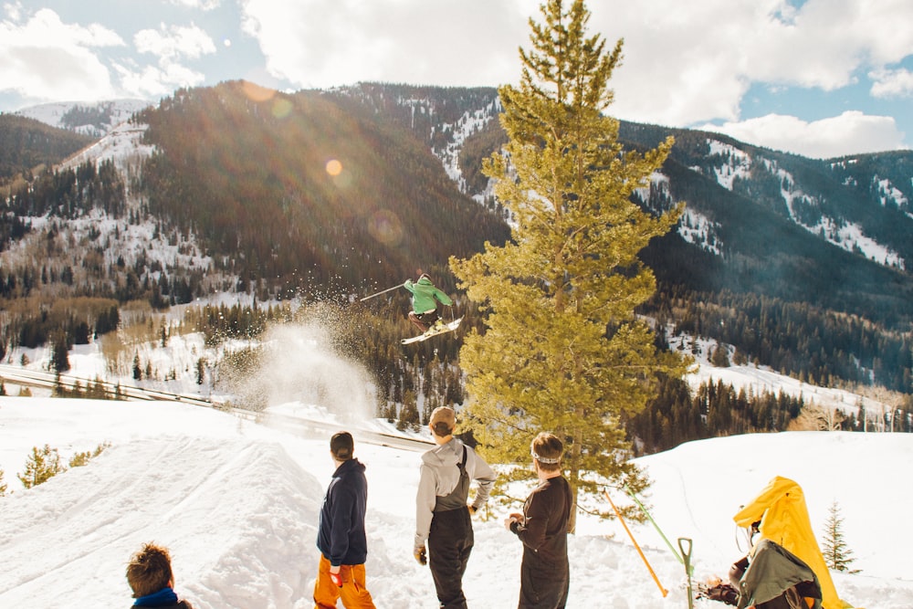 group of people on mountain peak during daytime