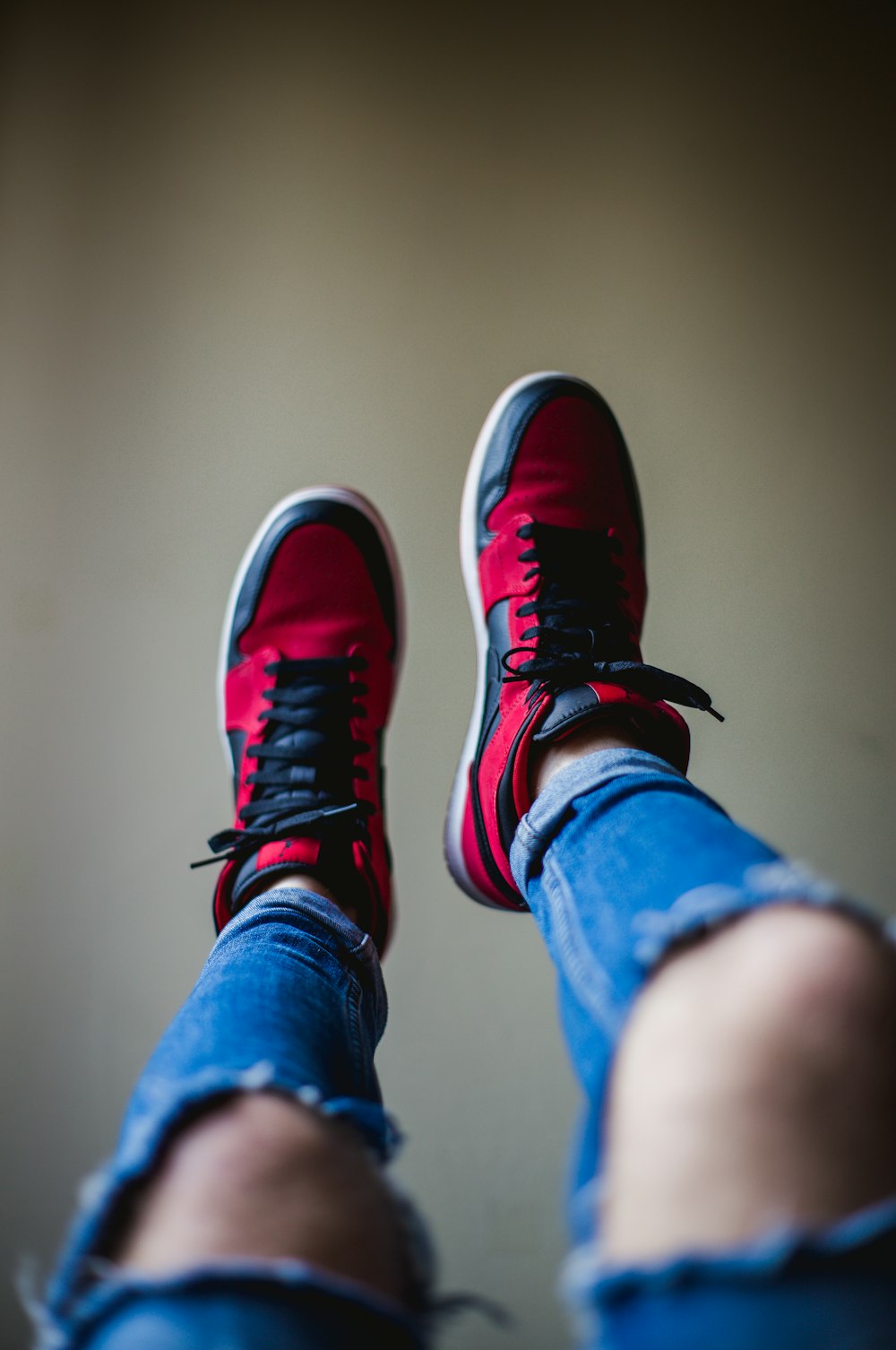 shallow focus photography of red-and-black shoes