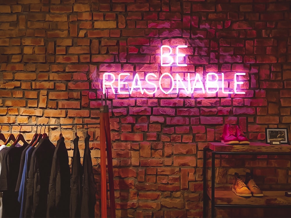 Be Reasonable neon signage