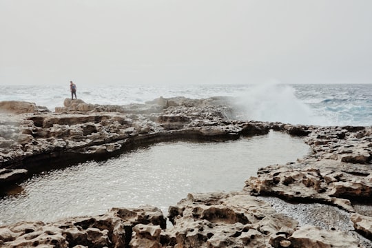 person standing near body of water during daytime in Gozo Malta