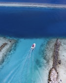 birds eye view of white boat on body of water