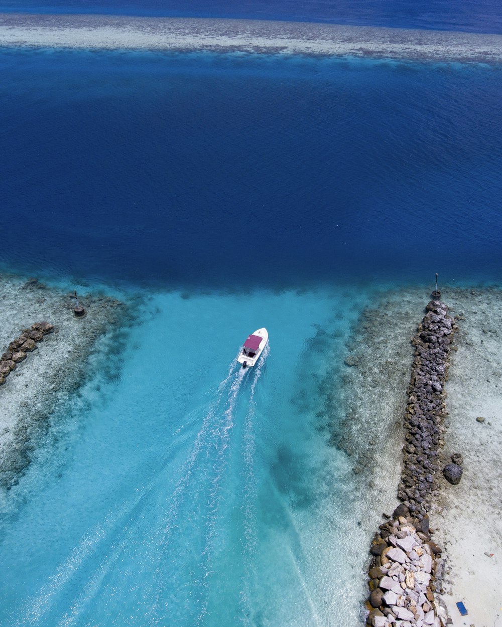 birds eye view of white boat on body of water