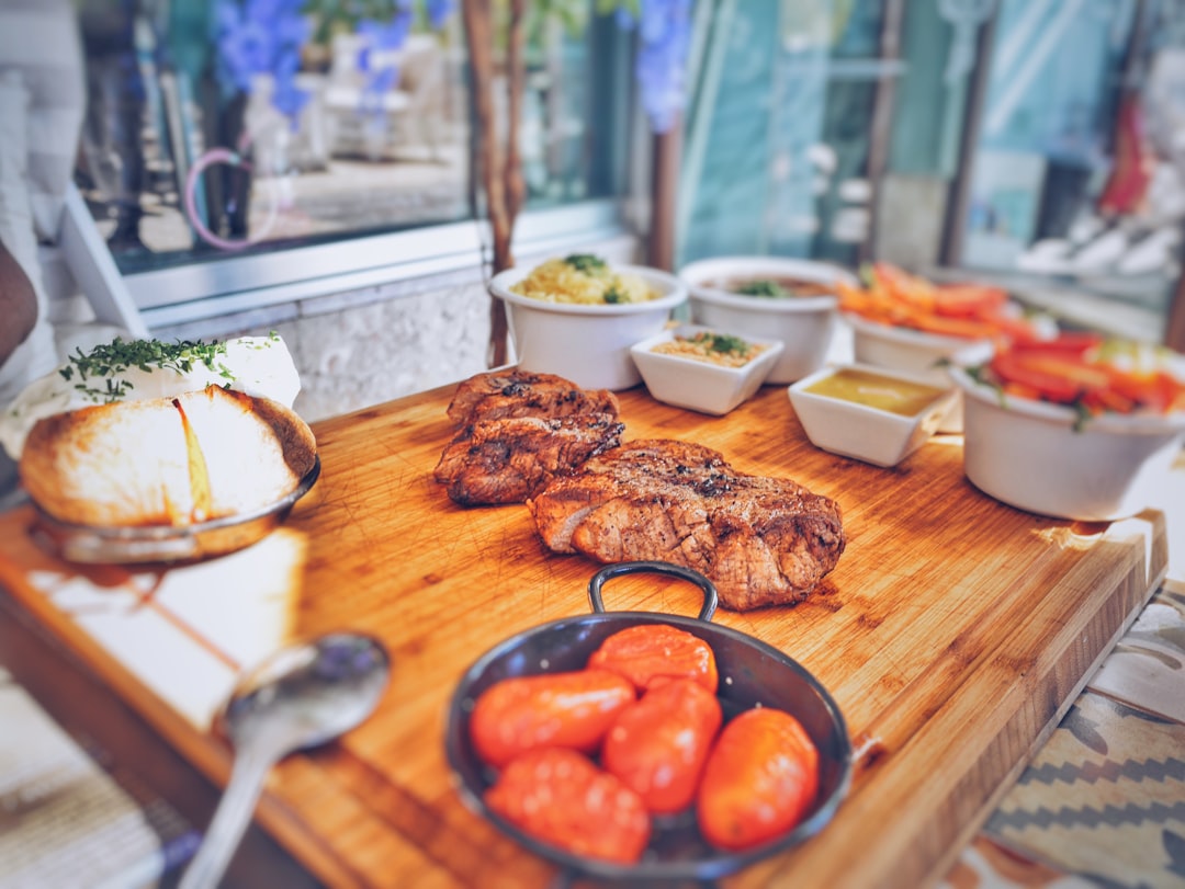 grilled meat on brown wooden tray, The Club Steakhouse