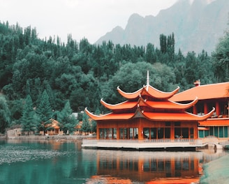 orange wooden building near green trees at daytime