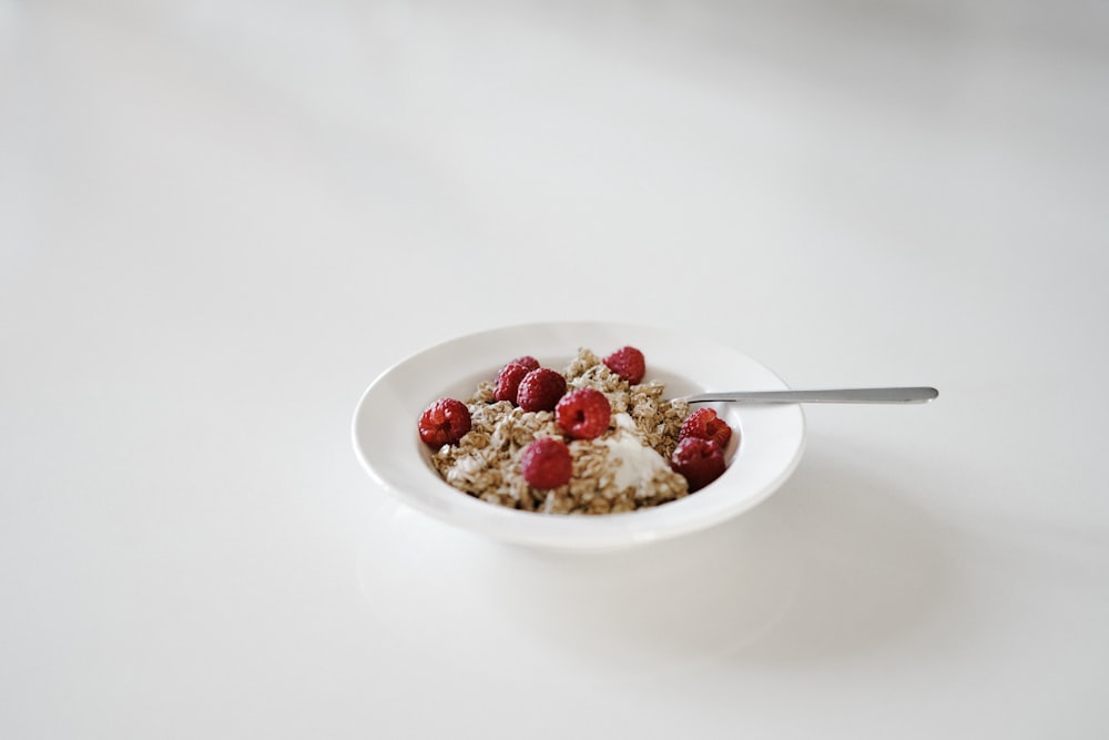 round white ceramic bowl with dessert and gray spoon