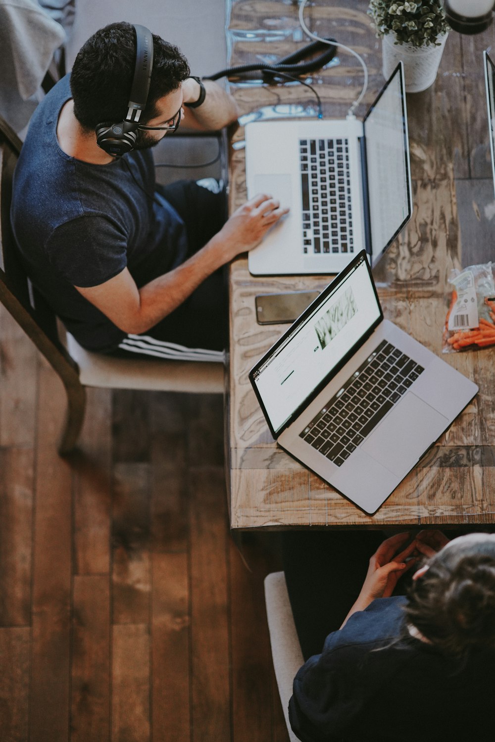 man sitting on chair and looking laptop computer