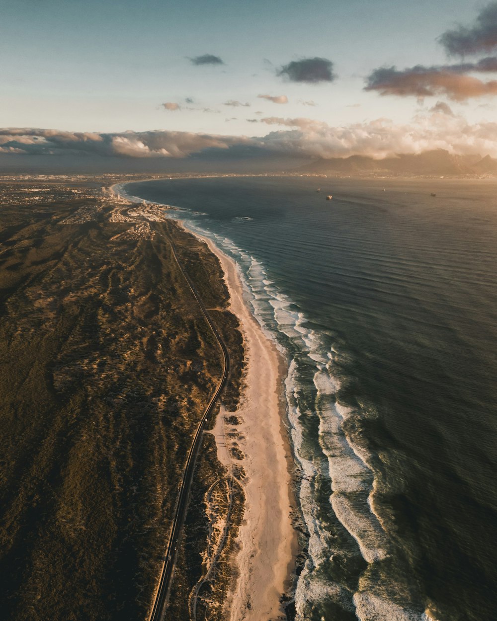 brown sand near body of water during daytime