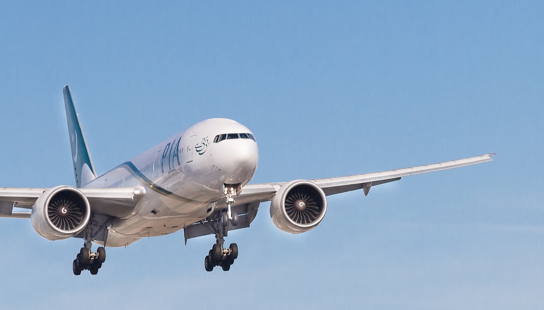 white PIA airplane, 777 on Final