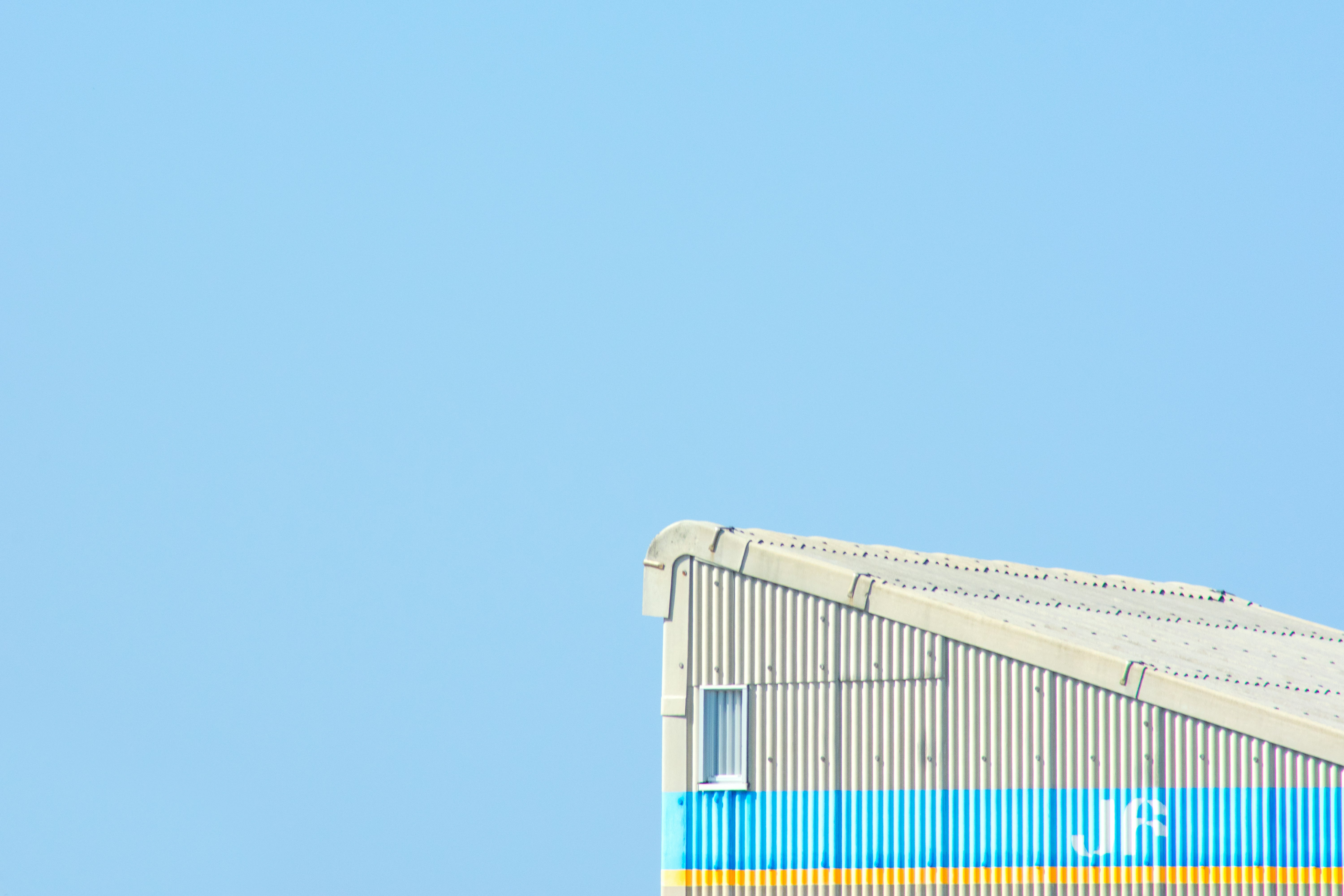 white and blue building under clear sky