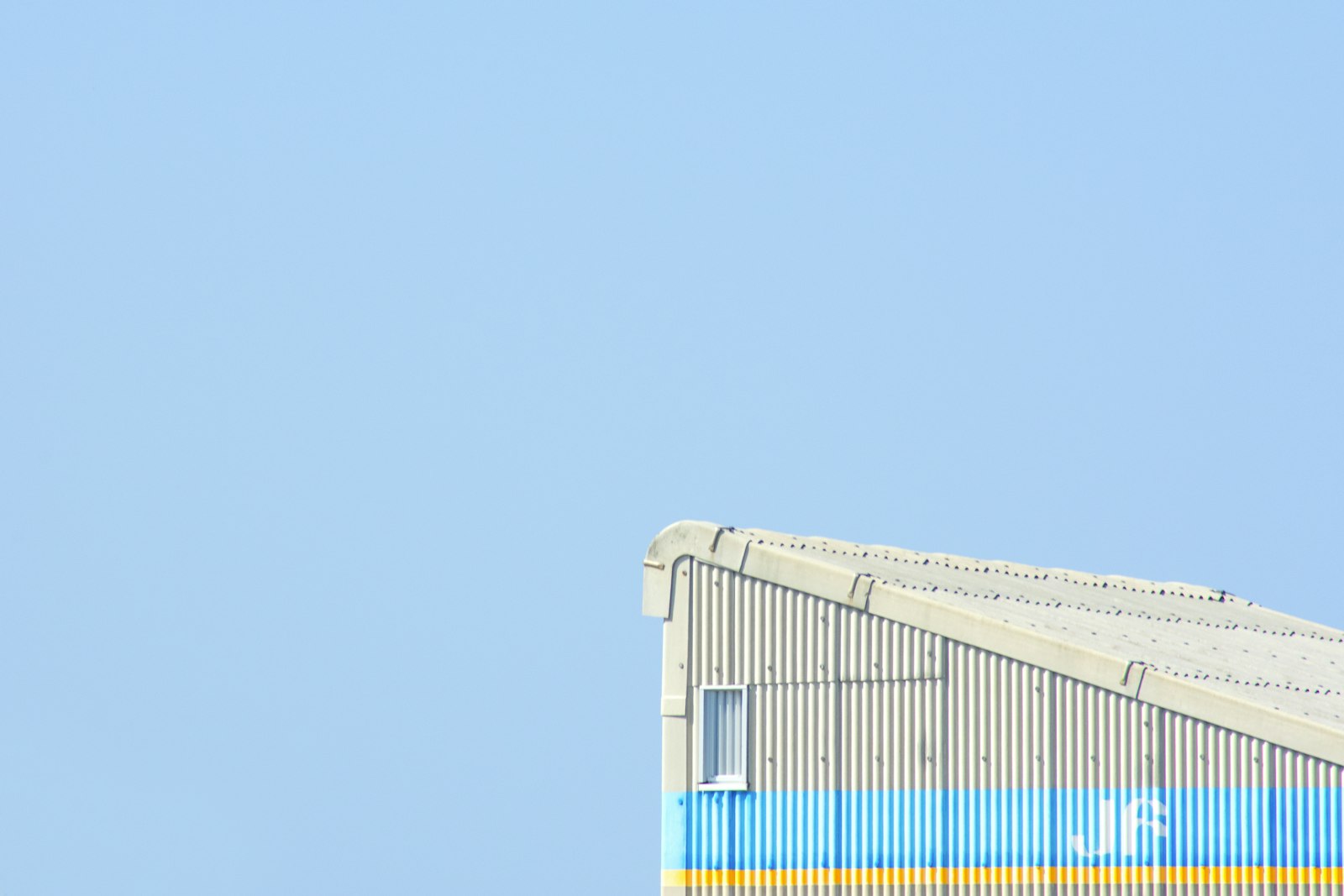 Nikon D3400 + Sigma 50-150mm F2.8 EX APO DC HSM II + 1.4x sample photo. White and blue building photography