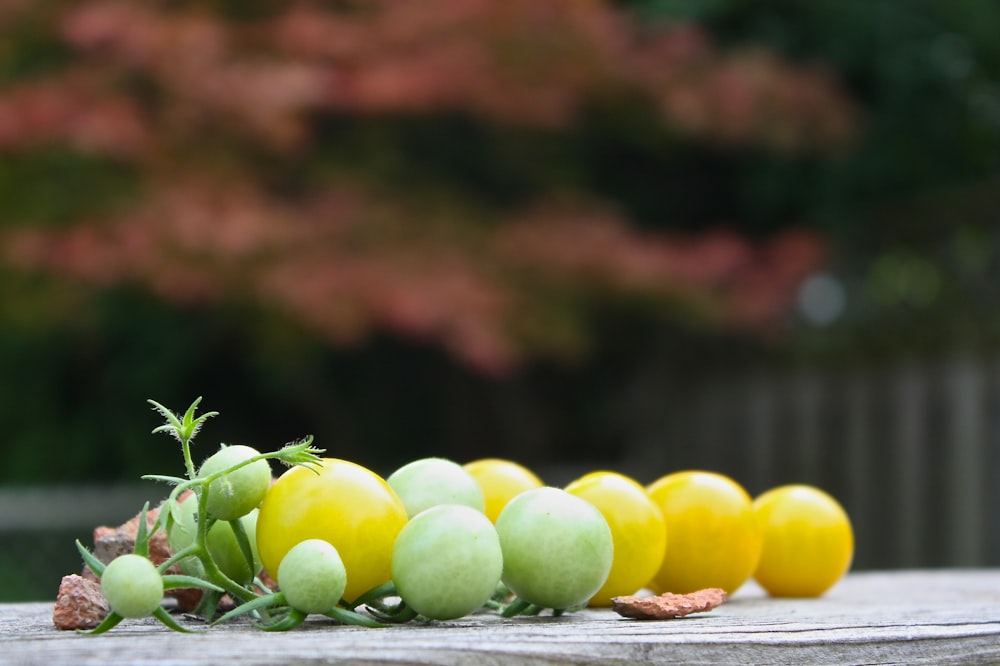 green and yellow fruits on table