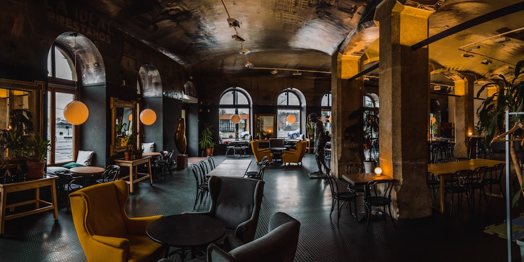 tables and chairs inside building, One coffee please