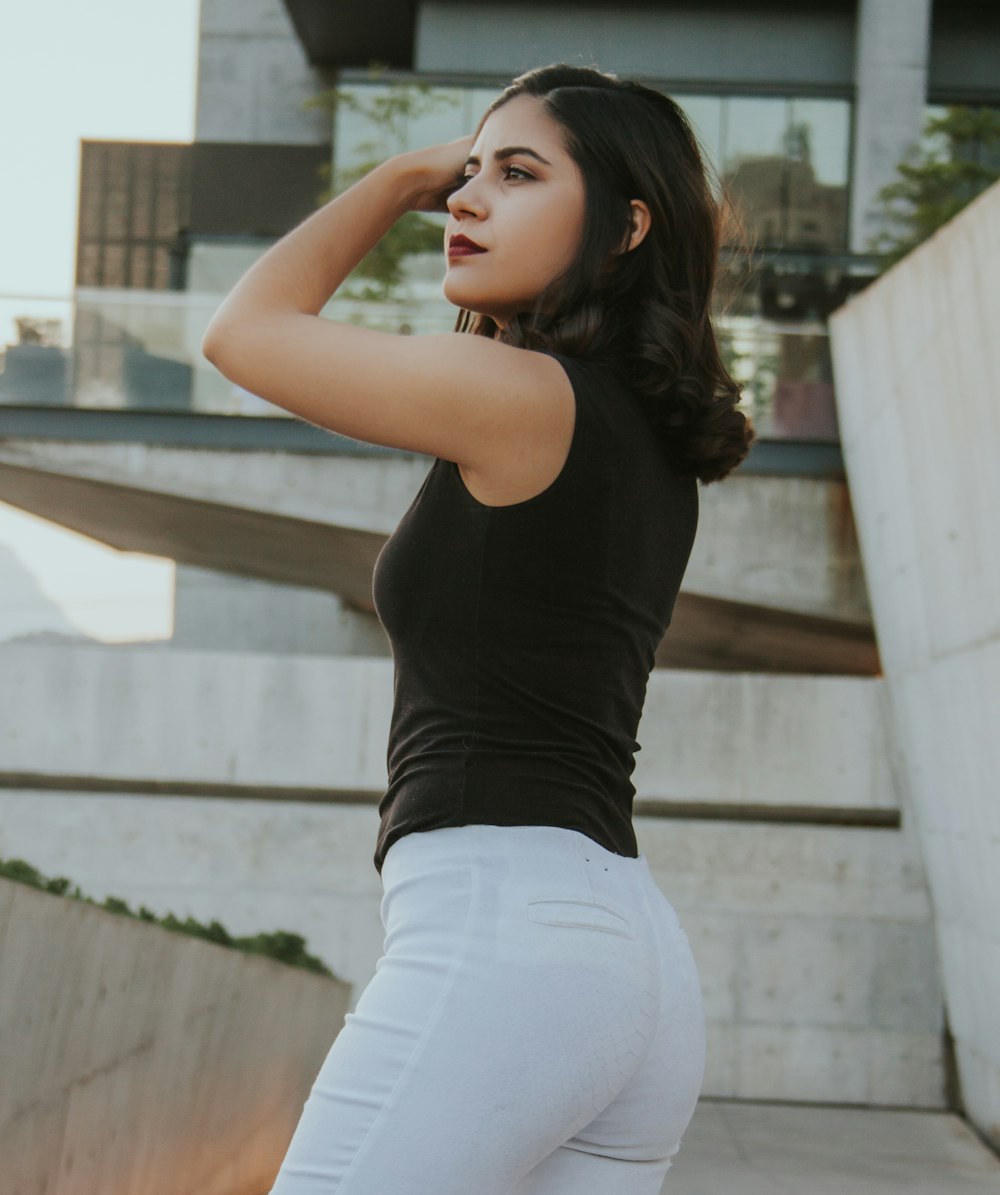 women's black tank top and white pants