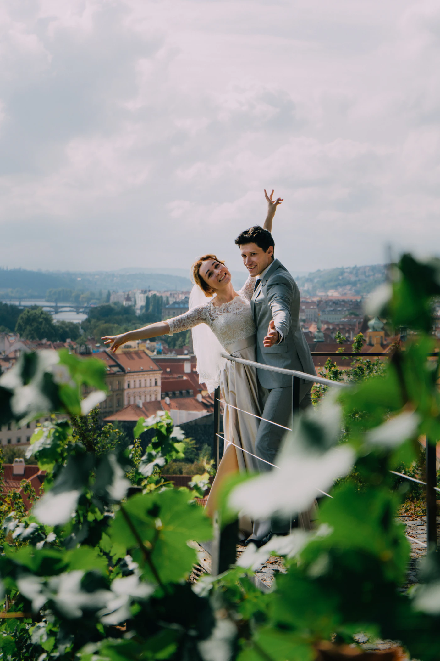 Couple in elopement ceremony attire on a side street of Old Quebec City with the Chateau Frontenac visible at the end of the street and the stone buildings of the Upper Town surrounding them