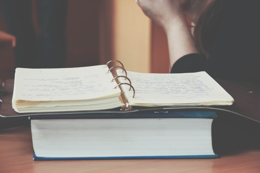 person in front of opened book